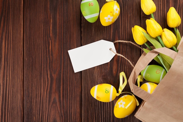 Easter eggs and tulips in paper bag