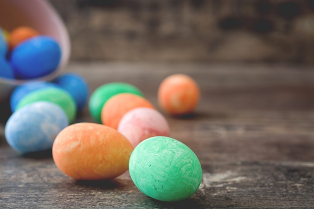 Easter eggs in a vintage bowl on wooden table close up