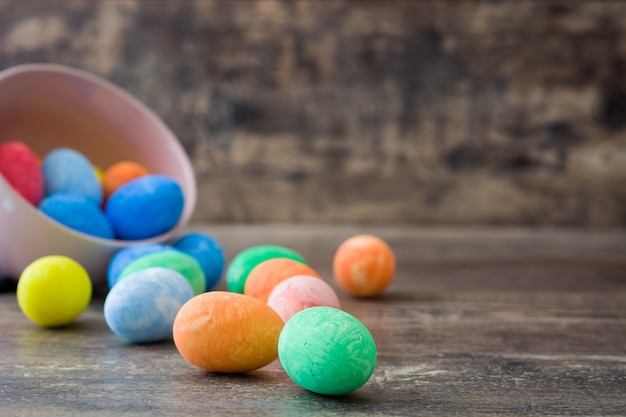 Easter eggs in a vintage bowl on wooden table