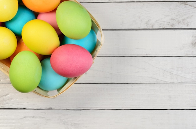 Easter eggs on a white wooden plank