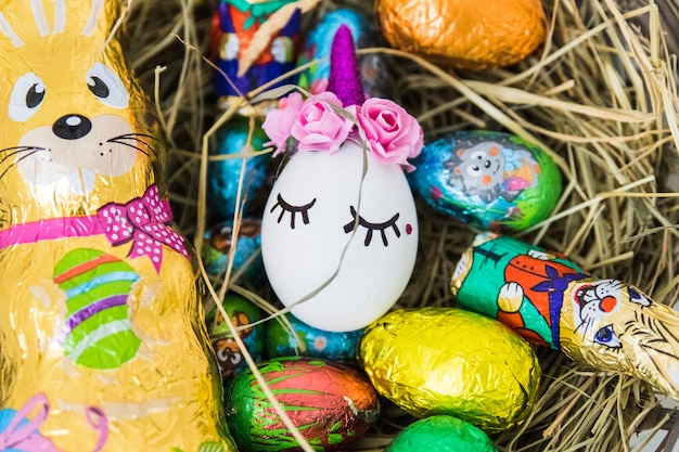 Easter eggs over wicker basket with hay