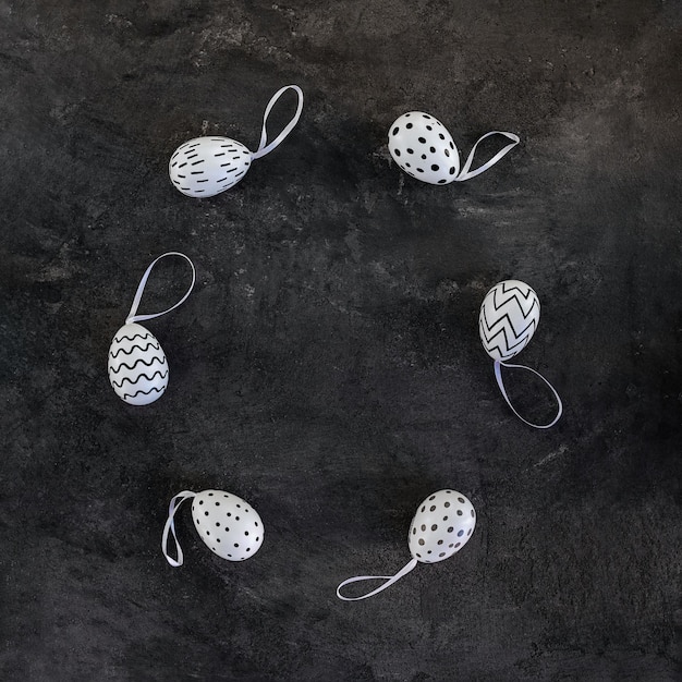 Easter eggs with a black and white pattern on a black background