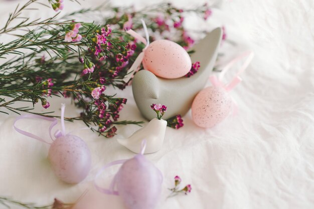 Easter eggs with flowers on white linen fabric Spring and Easter concept