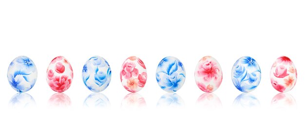 Easter eggs with red and blue floral pattern on white isolated background.