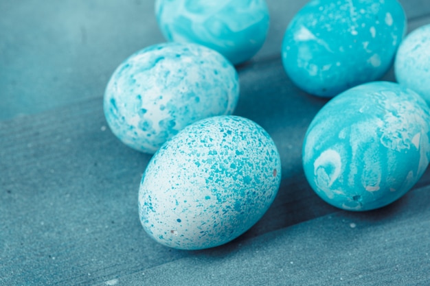 Easter eggs with tulips on blue wooden 