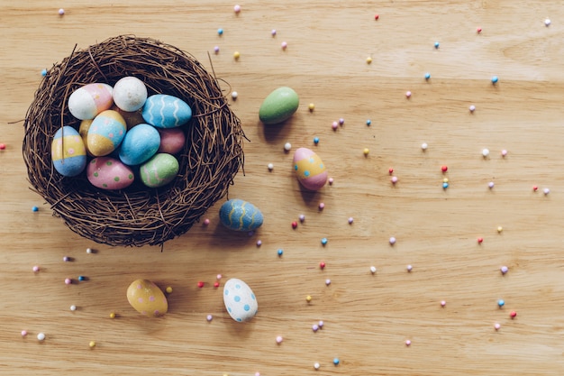 Easter eggs on on wood background top view with natural light. Flat lay style.