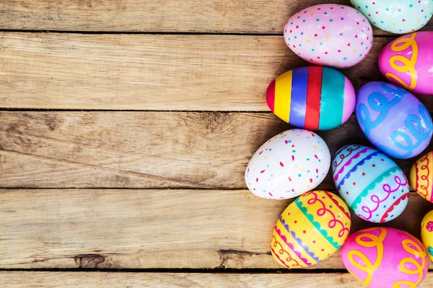 Easter eggs on wooden background with space