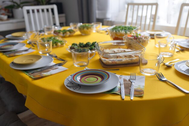 Easter family celebration traditional polish dishes on a wooden table with yellow tablecloth high