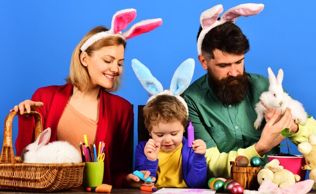 Easter family traditions happy mother father and little son in bunny ears preparing for holidays