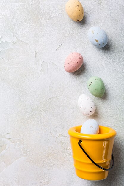 Easter flat lay with yellow ceramic bucket