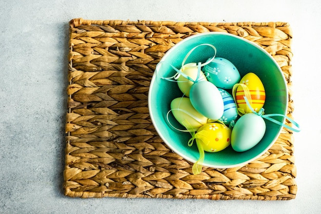 Easter frame concept with daffodils and eggs on concrete background
