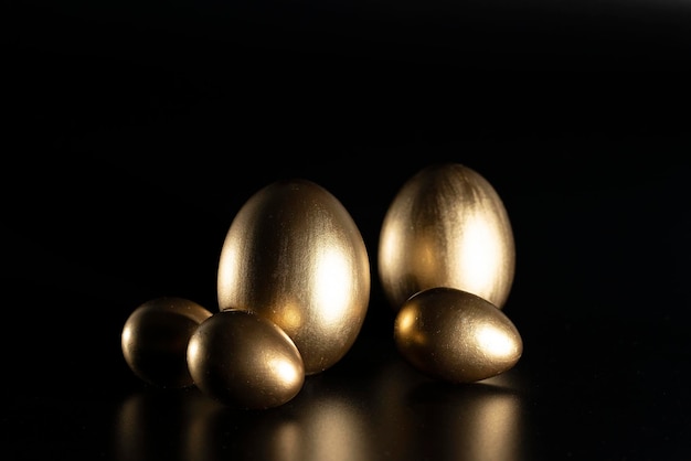 Easter, Gold birds eggs shot against a dark background