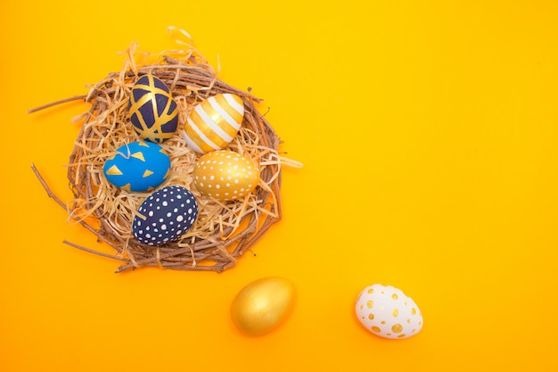 Easter golden decorated eggs on a nest