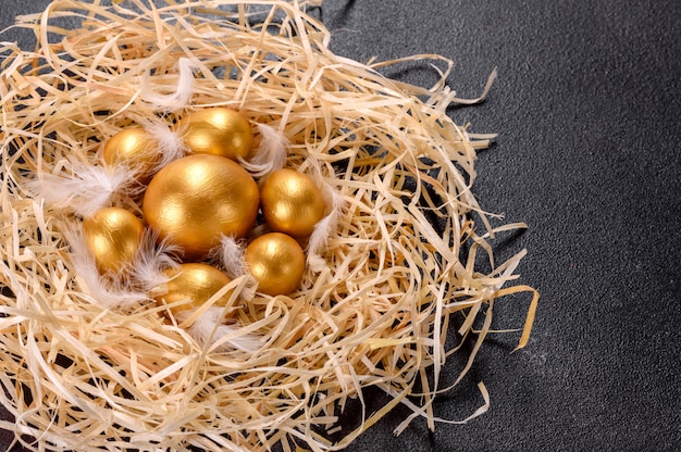 Easter golden eggs in the nest, preparation for the holiday. Golden eggs in nest