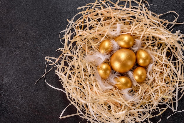 Easter golden eggs in the nest, preparation for the holiday. Golden eggs in nest
