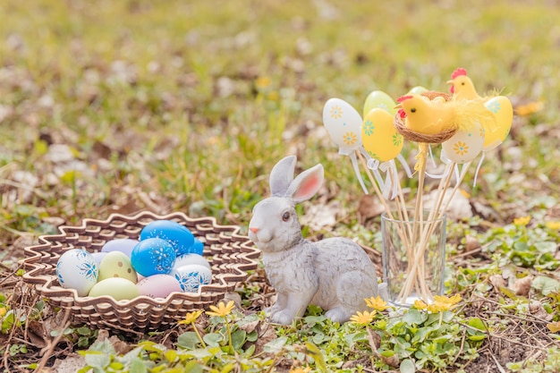 Easter greeting card Easter bunny and Easter eggs on green grass field spring meadow