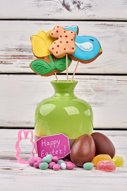 Easter greeting card and sweets Confectionery on wooden surface Easter present for sweet tooth