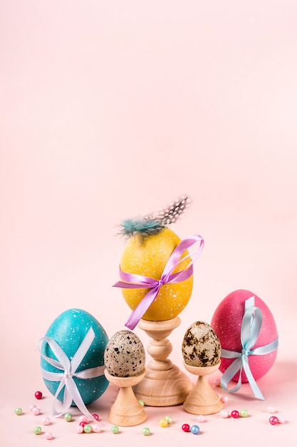 Easter greeting card with decorated eggs, feathers and beads