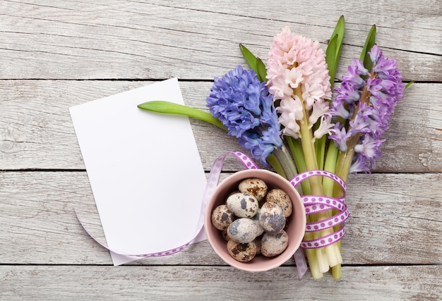 Easter greeting card with easter eggs and hyacinth flowers