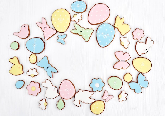 Easter greeting card with gingerbread cookies. Easter spring decorative composition with homemade easter cookies in shape of funny rabbit and eggs