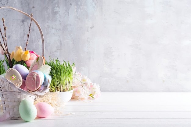照片复活节贺卡与釉面饼干和丰富多彩的复活节鸡蛋在篮子里。与复制空间