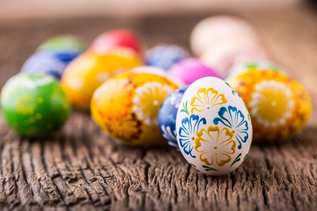 Easter. Hand made easter eggs on old wooden table.