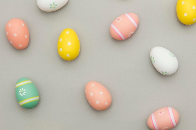 Easter holiday background Pastel coloured decorated easter eggs on a grey background