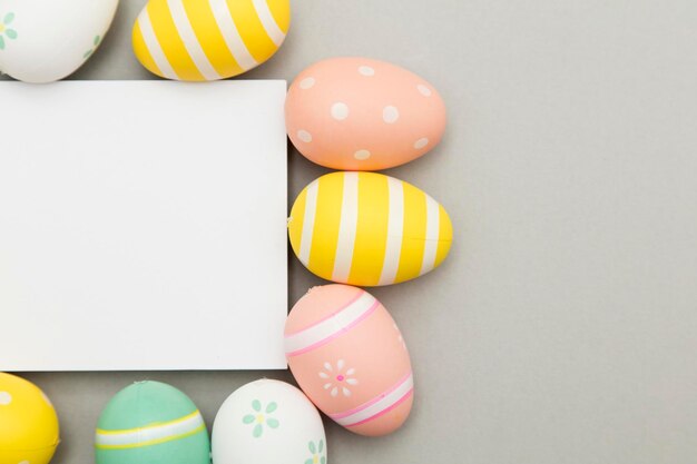 Easter holiday background Pastel coloured decorated easter eggs with a blank white label