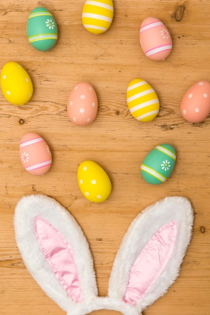 Easter holiday background with bunny ears and easter eggs