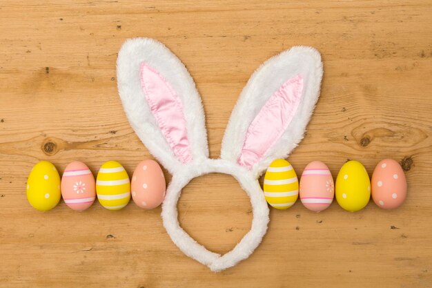 Easter holiday background with bunny ears and easter eggs