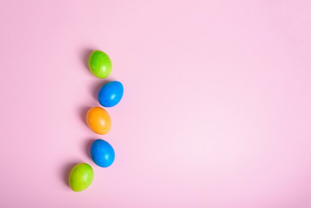 Easter holiday colorful painted eggs on a pastel pink background. composition easter.