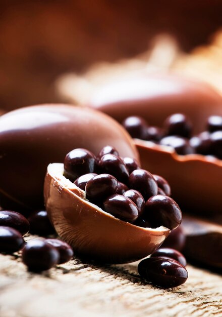 Easter holiday composition with chocolate eggs and sweets rustic style vintage wooden background selective focus