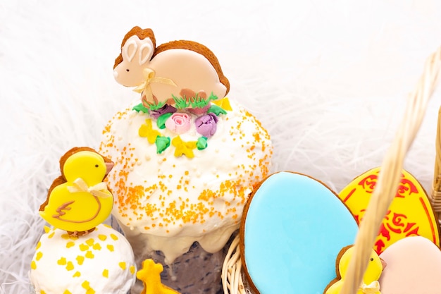 Easter holiday. Easter gingerbread chicken and rabbit on the Easter cake.  on a light background.