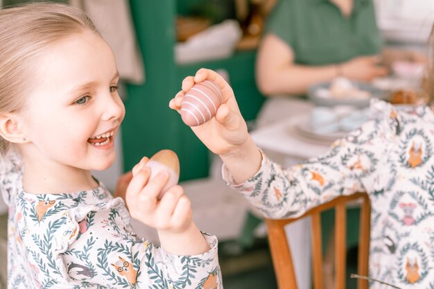 写真 春の季節のイースターの休日の時間幸せな家族の率直な小さな子供の姉妹の女の子一緒に母のお母さんは家庭で楽しい時を過す