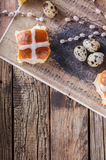 Easter Hot Cross Buns on wooden background