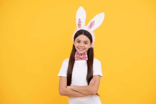 Easter hunt begins. happy easter. childhood happiness. child in\
rabbit ears and bow tie. time for fun. adorable kid looking funny.\
paschal spring holiday. happy teen girl wear bunny ears.