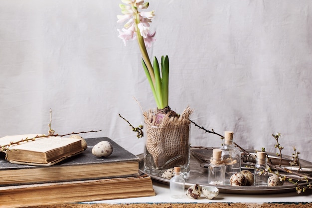 Easter interior with flower and old books