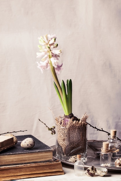 Easter interior with flower and old books