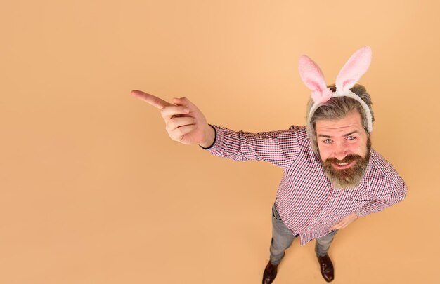 easter man points finger on copy space sale discount season sales happy easter man in bunny ears