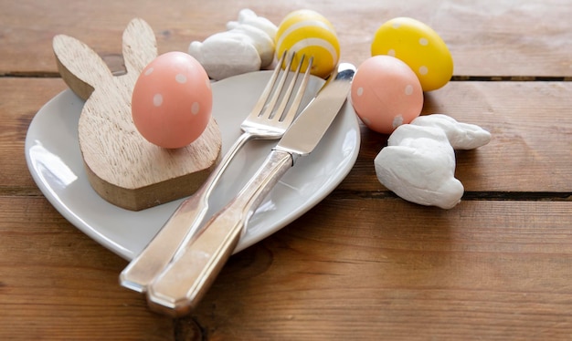 Easter meal table decorated with springtime easter bunny and easter eggs