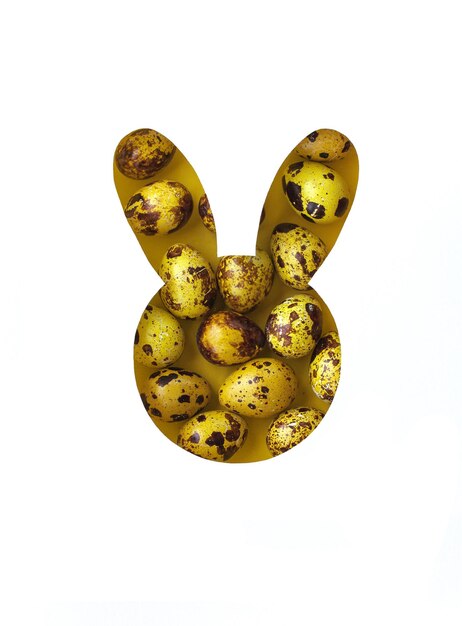 Easter minimal background with a silhouette of a bunny made of yellow eggs. Creative concept of Happy Easter Flat lay, top view