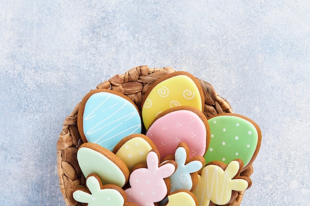 Easter multicolored gingerbread, candy and scattered confectionery topping dressing on gray table. Easter baking table. Celebratory table concept. Space for text.