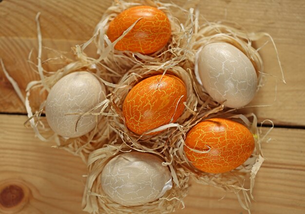 Easter. Orange and beige Easter eggs on wooden surface