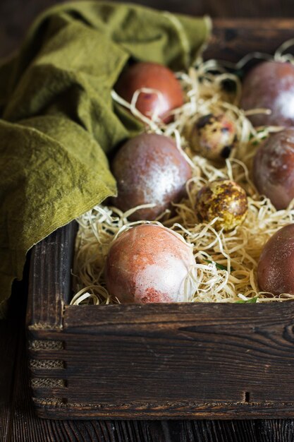 Easter painted eggs in a wooden box Rustic style photography