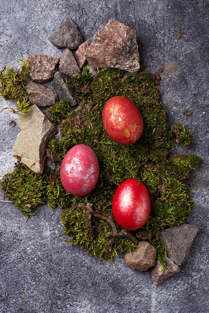Easter painted red eggs on moss