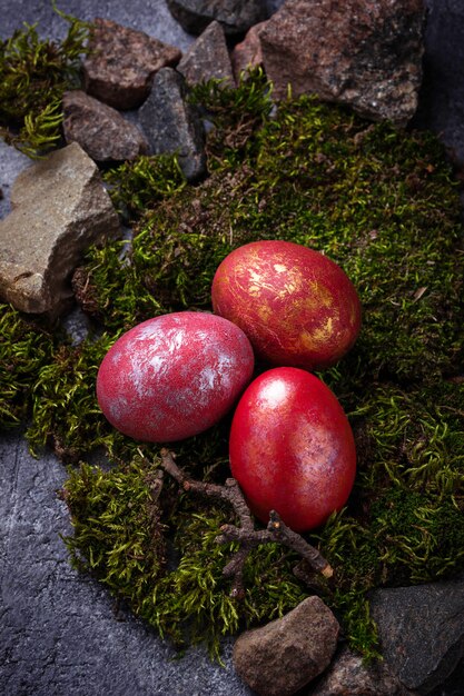 Easter painted red eggs on moss