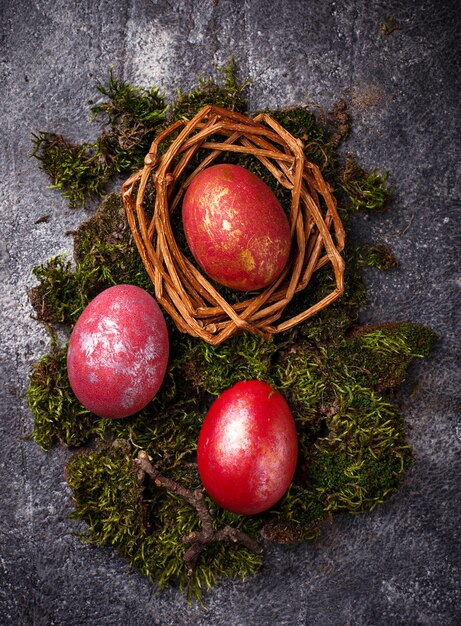 Easter painted red eggs on nest