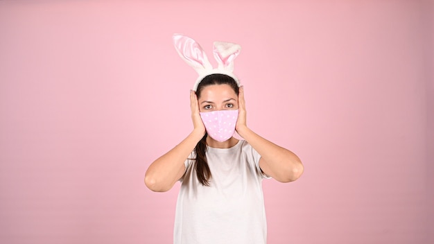 Easter in a pandemic, on a pink background. High quality photo