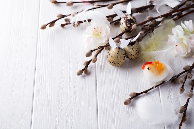 Easter quail eggs with hare ears and willow branch