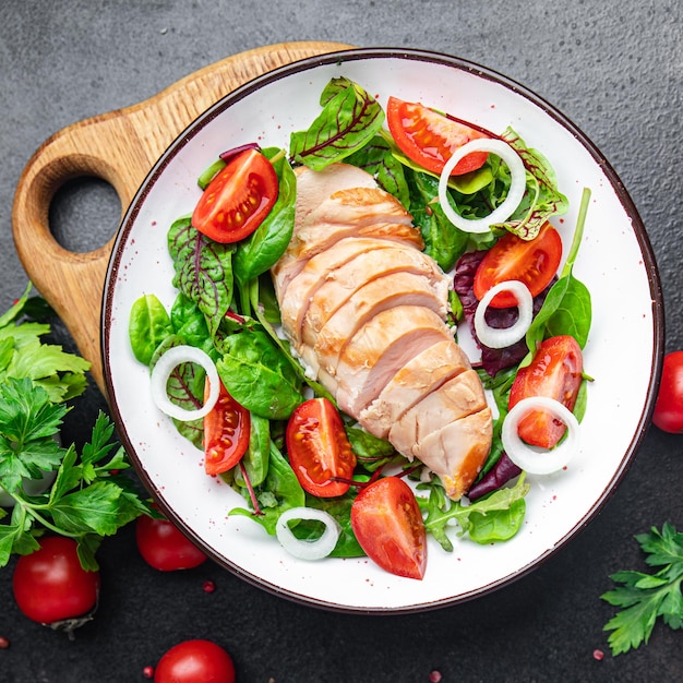 Easter salad chicken breast with vegetables tomato onion green lettuce mix leaves veggie fresh